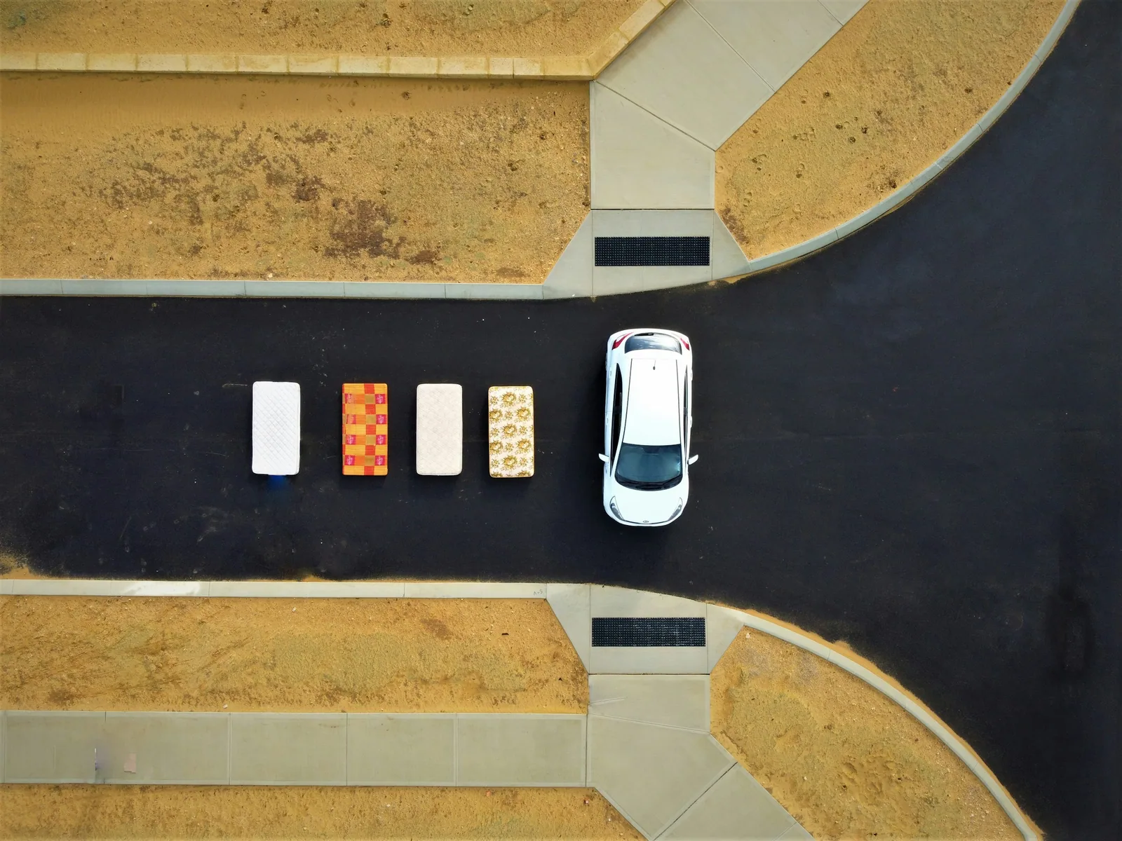 Aerial view of a car parked neatly beside a row of parked cars